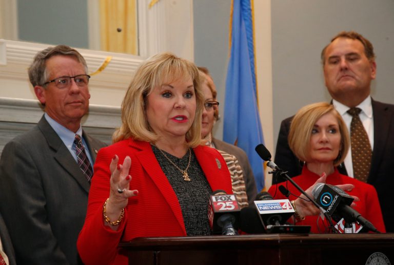 Surrounded by legislators, Oklahoma Gov. Mary Fallin speaks before signing revenue bills and a teacher pay raise bill in Oklahoma City, Thursday, March 29, 2018.