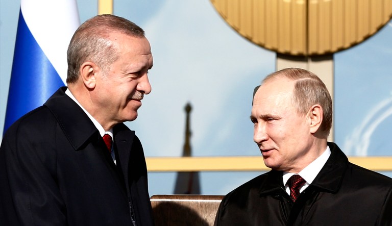 Turkey's President Recep Tayyip Erdogan left, and Russia's President Vladimir Putin, right, shake hands during a welcome ceremony in Ankara, Turkey.