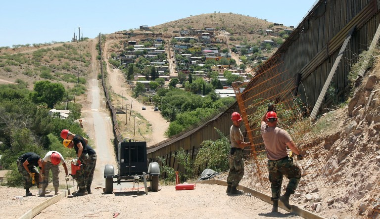 FILE--In this June 19, 2008, file photo, members of the 200th Red Horse Air National Guard Civil Engineering Squadron from Camp Perry in Ohio, work on building a road at the border in Nogales, Ariz. In his threat Tuesday, April 3, 2018, to use the military on the U.S.-Mexico border until his promised wall is built, President Donald Trump again heaped blame on his predecessor, Barack Obama, and congressional Democrats for creating a dangerous and dysfunctional border.
