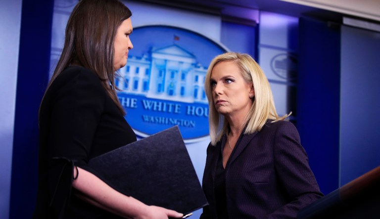 Homeland Security Secretary Kirstjen Nielsen, right, turns over the podium to White House press secretary Sarah Huckabee Sanders during the daily press briefing in the Brady press briefing room at the White House, in Washington, Wednesday, April 4, 2018. 
