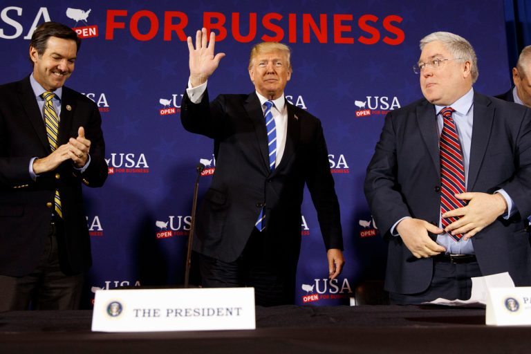 Rep. Evan Jenkins, R-W.Va., left, and West Virginia Attorney General Patrick Morrisey, right, watch as President Donald Trump arrives for a roundtable discussion on tax policy, Thursday, April 5, 2018, in White Sulphur Springs, W.Va.