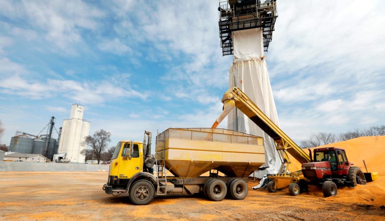 Works move corn to a storage bin at the Heartland Co-op, Thursday, April 5, 2018, in Redfield, Iowa.