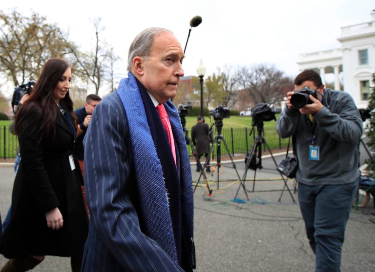 White House chief economic adviser Larry Kudlow, left, walks back to West Wing after talking to reporters outside the White House in Washington, Friday, April 6, 2018.