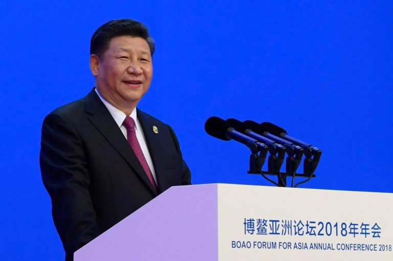 In this photo released by Xinhua News Agency, Chinese President Xi Jinping delivers his opening speech at the Boao Forum for Asia Annual Conference in Boao in south China's Hainan province, Tuesday, April 10, 2018. Xi promised to cut auto import taxes, open China's markets further and improve conditions for foreign companies in a speech Tuesday that called for international cooperation against a backdrop of a spiraling dispute with Washington over trade and technology.