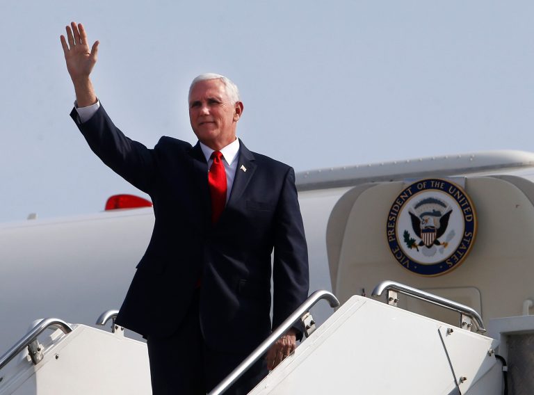 Vice President Mike Pence waves as he arrives at Jorge Chavez International Airport in Lima, Peru, on Friday. Pence is in Lima to attend the Americas Summit.