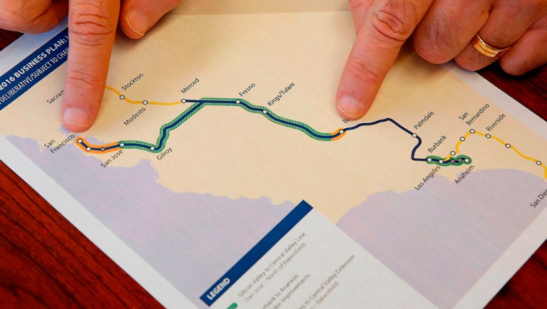 Dan Richard, chairman of the board that oversees the California High-Speed Rail Authority, gestures to a map showing the proposed initial construction of the bullet train.