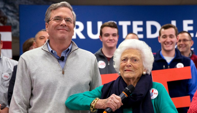 FILE - In this Feb. 4, 2016, file photo, Barbara Bush, right, jokes with her son Republican presidential candidate, former Florida Gov. Jeb Bush, while introducing him at a town hall meeting at West Running Brook Middle School in Derry, N.H. A family spokesman said Tuesday, April 17, 2018, that former first lady Barbara Bush has died at the age of 92. (AP Photo/Jacquelyn Martin, File)