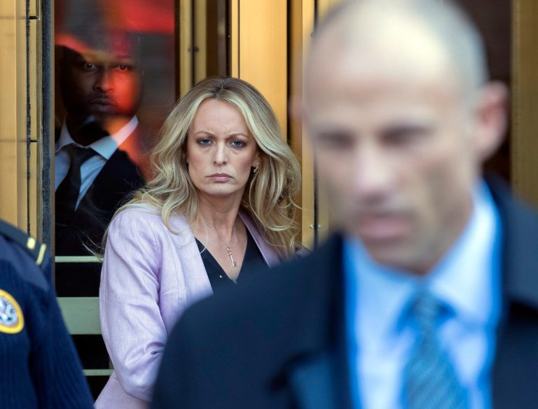 Adult film actress Stormy Daniels, left, follows her attorney Michael Avenatti, right, as she leaves federal court, Monday, April 16, 2018, in New York.