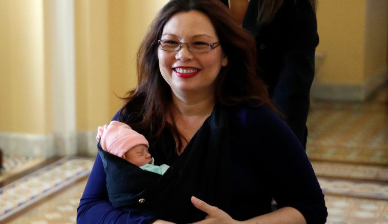 Sen. Tammy Duckworth, D-Ill., carries her baby Maile Pearl Bowlsbey after they went to the Senate floor to vote, on Capitol Hill, Thursday, April 19, 2018 in Washington.