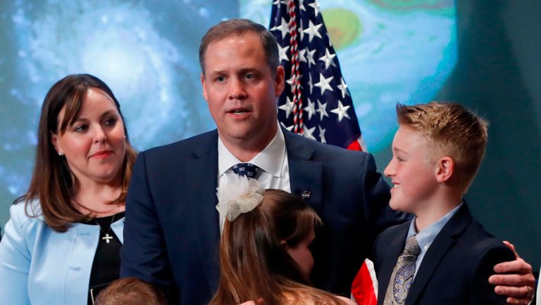 Jim Bridenstine, the new NASA administrator, with his children, Walker, far right, Sarah, center, and Grant, on stage following his swearing-in ceremony, Monday, April 23, 2018, at NASA Headquarters in Washington. Looking on is Bridenstine's wife, Michelle. (AP Photo/Pablo Martinez Monsivais)