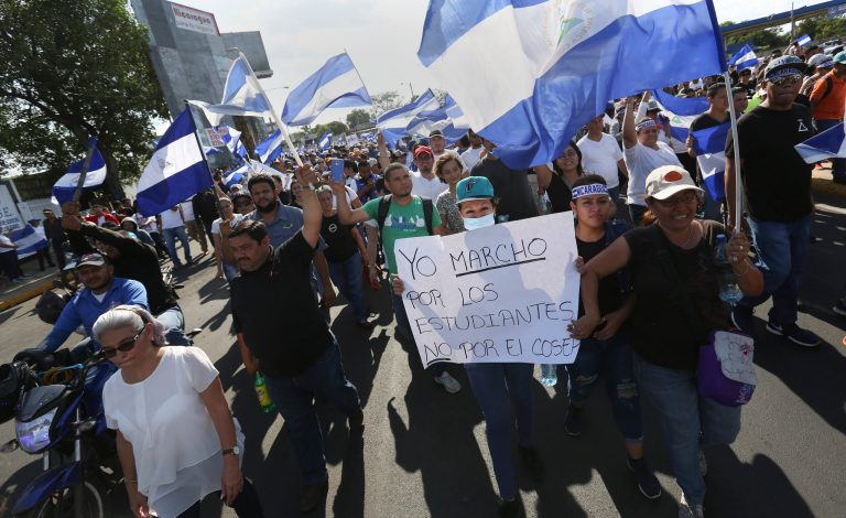 People march with Nicaraguan national flags in a demonstration protesting government repression and a call for peace, in Managua, Nicaragua, Monday, April 23, 2018. Human rights groups say clashes between police and protesters left nearly 30 dead since people took to the streets last week to oppose tax hikes and benefit cuts meant to shore up the ailing social security system.
