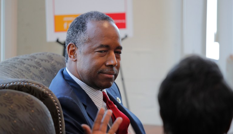 Housing and Urban Development Secretary Ben Carson listens to Denise Smith, who used to be homeless, at the Downtown Women's Center on April 24 in Los Angeles. Carson visited the center to discuss homelessness. 