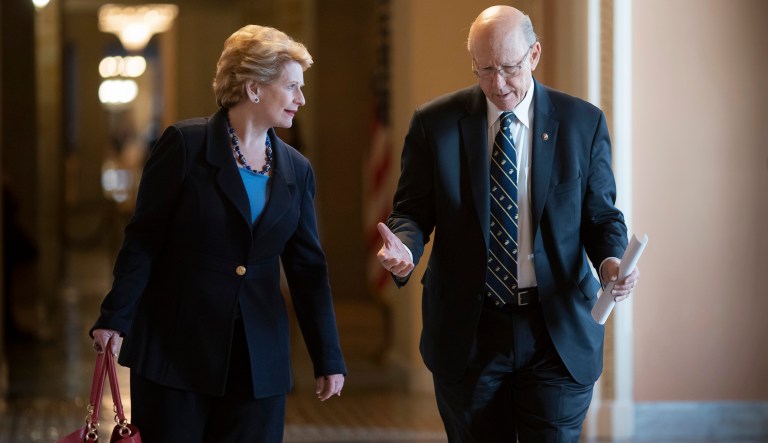 Ranking member Sen. Debbie Stabenow, D-Mich., and Senate Agriculture Committee Chairman Pat Roberts, R-Kan., walk to Senate chambers together on April 26, 2018.