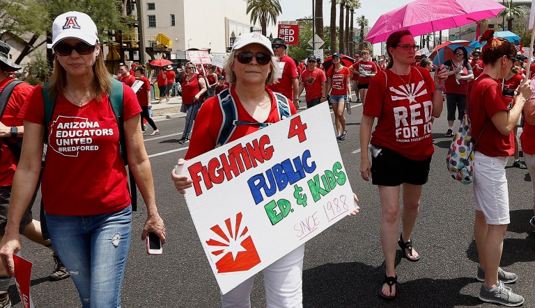 Thousands march to the Arizona Capitol for higher teacher pay and public school funding on the first day of a state-wide teachers strike on April 26, 2018, in Phoenix.