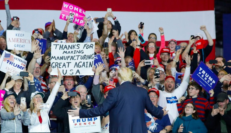 President Trump stops to look at supporters as he introduced at a rally in Washington, Mich. 