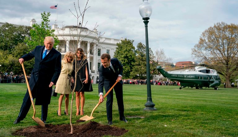 In this April 23, 2018 photo, first lady Melania Trump, second from right, and Brigitte Macron, second from left, watch as President Donald Trump and French President Emmanuel Macron participate in a tree planting ceremony on the South Lawn of the White House in Washington. 