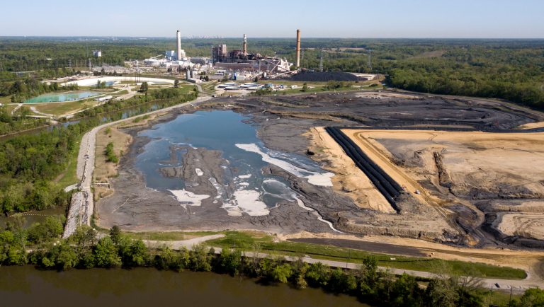 The Richmond city skyline can be seen on the horizon behind the coal ash ponds along the James River near Dominion Energy's Chesterfield Power Station in Chester, Va., Tuesday, May 1, 2018. Virginia's governor says the state has no plans to change its coal ash management practices, despite an Environmental Protection Agency proposal that would roll back federal regulations governing the byproduct generated by coal-burning power plants. 