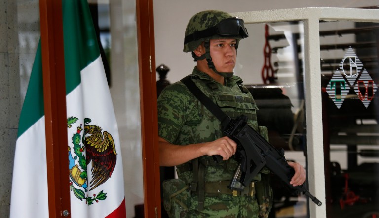 A soldier stands guard at Talleres Graficos de Mexico, where election ballots are printed in Mexico City, Sunday, May 6, 2018.