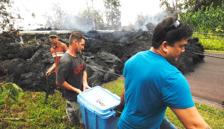 Residents evacuate as lava continues to overrun Hookupu Street in Pahoa, Hawaii. Hawaii's Kilauea volcano has destroyed homes and spewed lava hundreds of feet into the air, leaving evacuated residents unsure how long they might be displaced.