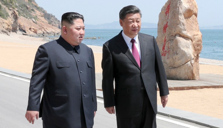 In this photo taken between May 7 and 8, 2018 released by Xinhua News Agency, Chinese President Xi Jinping, right, walks with North Korean leader Kim Jong Un during a meeting in Dalian in northeastern China's Liaoning Province. 