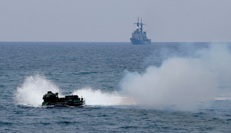 A U.S. Marine amphibious assault vehicle, with both Philippine and U.S. Marines on board, prepares to storm the beach during an amphibious landing exercise in the South China Sea, Wednesday, May 9, 2018.