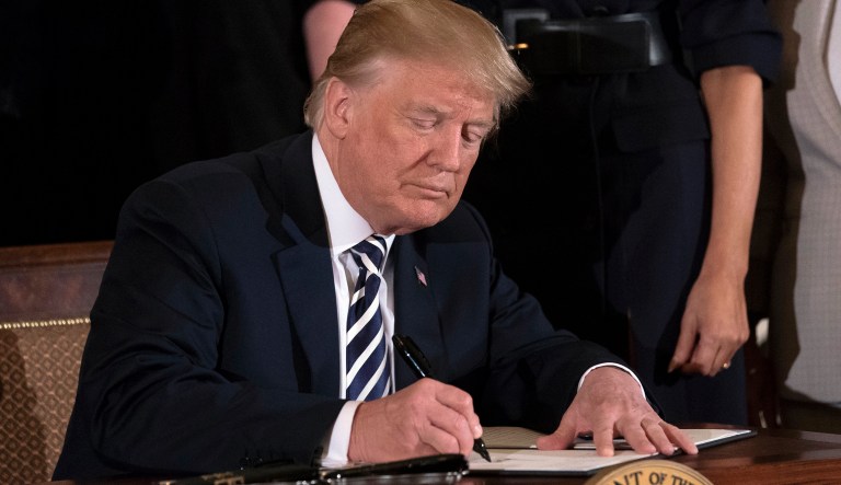 President Trump signs an executive order in the East Room of the White House in Washington, Wednesday, May 9, 2018, during an event celebrating military mothers and spouses.