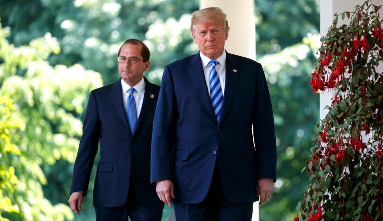 President Trump and Secretary of Health and Human Services Alex Azar arrive for an event about prescription drug prices in the Rose Garden of the White House in Washington, D.C.
