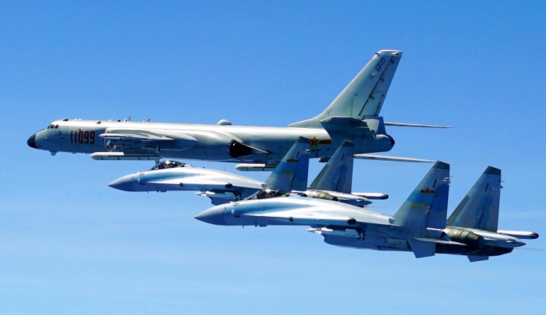 In this photo released by Xinhua News Agency and taken Friday, May 11, 2018, two Su-35 fighter jets and a H-6K bomber from the People's Liberation Army air force fly in formation during patrol that included the Luzon Straits also known as Bashi Straits near Taiwan.