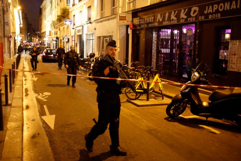 A police officer cordons off the area after a knife attack in central Paris, Saturday May 12, 2018. The Paris police said the attacker was subdued by officers during the stabbing attack in the 2nd arrondissement or district of the French capital Saturday. 