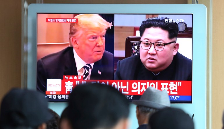 People watch a TV screen showing file footage of President Trump, left, and North Korean leader Kim Jong Un during a news program at the Seoul Railway Station in Seoul, South Korea.