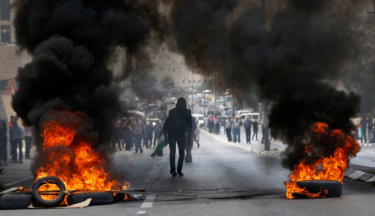 Palestinians clash with Israeli troops following a protest against the U.S. decision to relocate it's Israeli embassy to Jerusalem, in the West Bank city of Bethlehem, Monday, May 14, 2018. Several thousand people gathered in the center of Ramallah, while hundreds marched to the Qalandiya crossing on the outskirts of Jerusalem, where protesters threw stones at Israeli troops with their anger fueled by the embassy opening.  