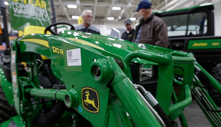 In this Feb. 23, 2018, file photo, a John Deere tractor is on display at the "Spring into Spring" home and garden trade show in Council Bluffs, Iowa. Deere & Co. reports earnings Friday, May 19.