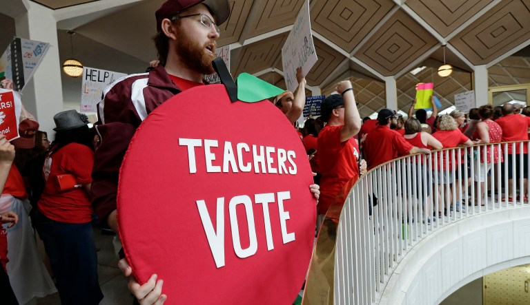 Kevin Poirier, an educator from West Charlotte school gathers with other educators during a teachers rally at the General Assembly in Raleigh, N.C., Wednesday, May 16, 2018. Thousands of teachers rallied the state capital seeking a political showdown over wages and funding for public school classrooms. 