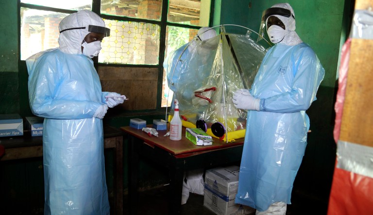 In this photo taken on Sunday, May 13, 2018, health care workers wear virus protective gear at a treatment center in Bikoro Democratic Republic of Congo. Congo's latest Ebola outbreak has spread to a city of more than 1 million people, a worrying shift as the deadly virus risks traveling more easily in densely populated areas. Two suspected cases of hemorrhagic fever were reported in the Wangata health zones that include Mbandaka, the capital of northwestern Equateur province. The city is about 150 kilometers (93 miles) from Bikoro, the rural area where the outbreak was announced last week, said Congo's Health Minister Oly Ilunga. 