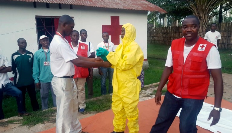 In this photo taken Monday, May 14, 2018, members of a Red Cross team don protective clothing before heading out to look for suspected victims of Ebola, in Mbandaka, Congo. Congo's Ebola outbreak has spread to Mbandaka, a crossroads city of more than 1 million people, in a troubling turn that marks one of the few times the vast, impoverished country has encountered the lethal virus in an urban area.