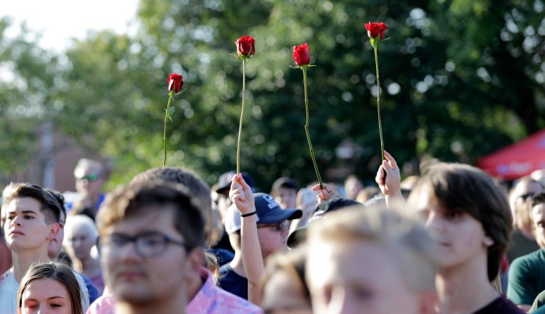 Roses are held up during a prayer vigil following a shooting at Santa Fe High School in Santa Fe, Texas, on Friday, May 18, 2018. 