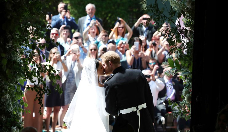 Prince Harry and Meghan Markle kiss on the steps of St George's Chapel after the wedding ceremony in Windsor, near London, England, on Saturday.