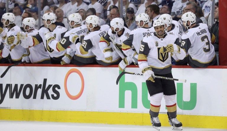 The Vegas Golden Knights celebrate after Ryan Reaves (75) scored during a hockey game.