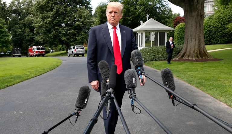 President Donald Trump approaches the microphones after walking out of the Oval Office on the South Lawn of the White House in Washington, Wednesday, May 23, 2018, in Washington, en route to a day trip to New York.  Trump will hold a roundtable discussion on Long Island on illegal immigration and gang violence that the White House is calling a "national call to action for legislative policy changes."