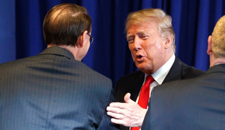 Deputy Attorney General Rod Rosenstein (left) shakes hands with President Trump during a roundtable on immigration policy at Morrelly Homeland Security Center on Wednesday in Bethpage, N.Y.