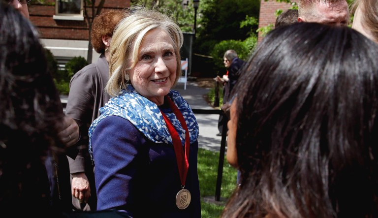 Hillary Clinton smiles as she shakes hands with guests while walking through Radcliffe Yard at Harvard University in Cambridge, Mass., Friday. Harvard University's Radcliffe Institute honored Clinton with the 2018 Radcliffe Medal.