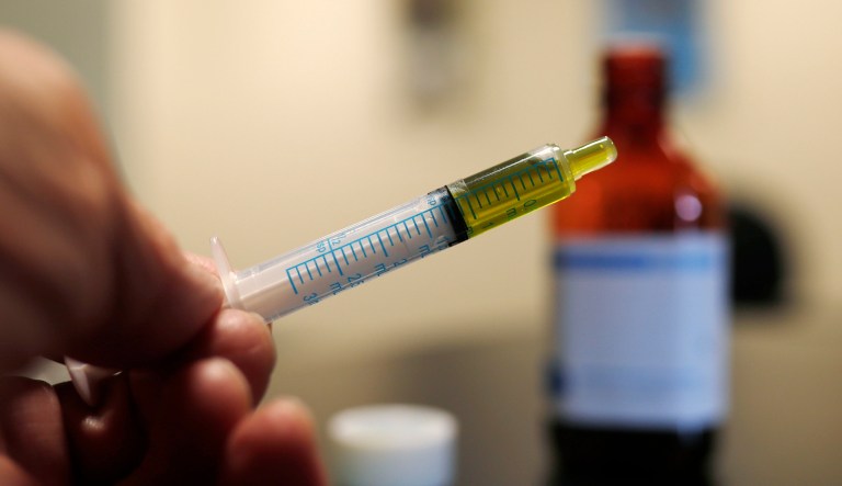 A syringe loaded with a dose of cannabidiol oil. 