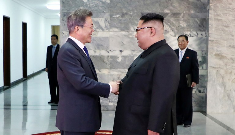 In this photo provided by South Korea Presidential Blue House via Yonhap News Agency, North Korean leader Kim Jong Un, right, and South Korean President Moon Jae-in, left, shake hands before their meeting at the northern side of the Panmunjom in North Korea on Saturday.