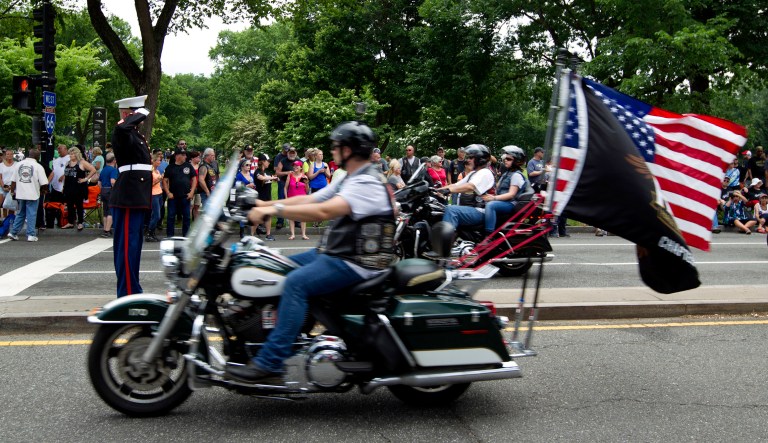 U.S. Marine Tim Chambers salutes to participants in the Rolling Thunder motorcycle rally in D.C.