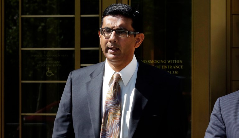 FILE - In this May 20, 2014 file photo, conservative scholar and filmmaker Dinesh D'Souza, left, accompanied by his lawyer Benjamin Brafman leaves federal court, in New York. President Donald Trump says he will pardon conservative commentator Dinesh D'Souza who pleaded guilty to campaign finance fraud. Trump tweeted Thursday: âWill be giving a Full Pardon to Dinesh DâSouza today. He was treated very unfairly by our government!â DâSouza was sentenced in 2014 to five yearsâ probation after he pleaded guilty to violating federal election law. 