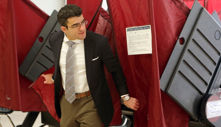 John Santoliquido steps out of a booth after voting in the state's primary election at Oakcrest High School, Tuesday, June 5, 2018, in Mays Landings, N.J.