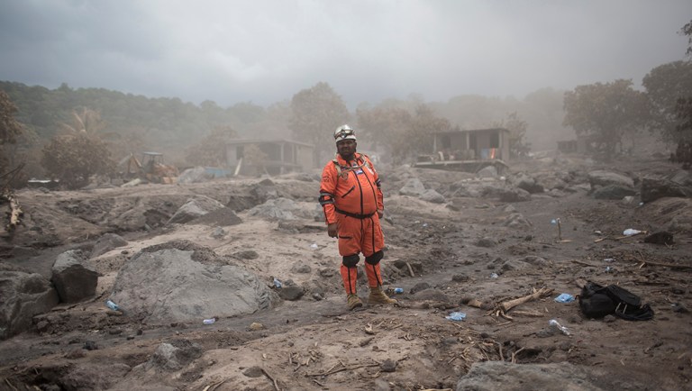 A member of the "Topos de Mexico" rescue group searches for missing persons from Volcan de Fuego or "Volcano of Fire" eruption in the San Miguel Los Lotes, Guatemala.