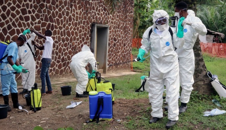 In this photo taken Thursday, May 31, 2018, Congolese health officials prepare to disinfect people and buildings at the general referral hospital in Mbandaka, Congo. For the first time since the Ebola virus was identified more than 40 years ago, a vaccine has been dispatched to front line health workers in an attempt to combat the epidemic from the onset.