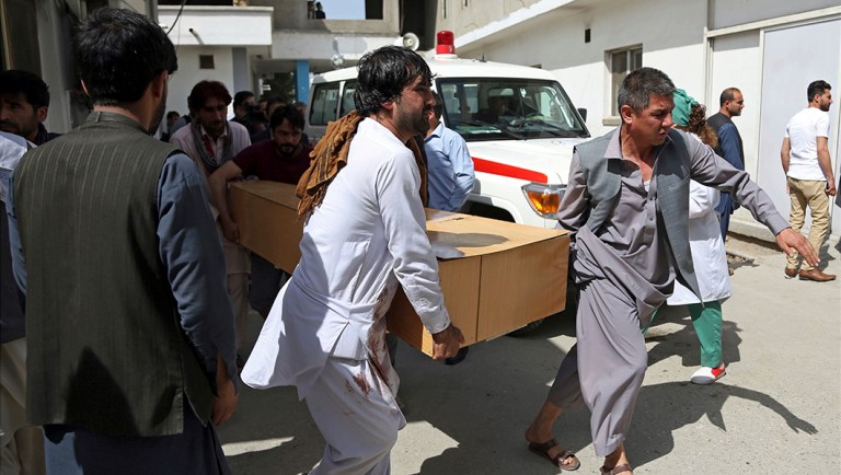 Relatives carry the coffin of a victim after a deadly suicide attack, in Kabul, Afghanistan.