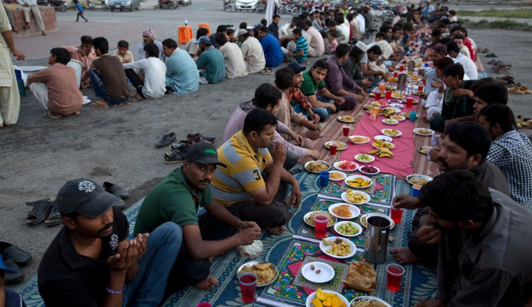 Pakistani wait to break their fast at a roadside during the Muslims' fasting month of Ramadan in Islamabad, Pakistan, Monday, June 11, 2018. Muslims throughout the world are celebrating Ramadan, the holiest month in the Islamic calendar.